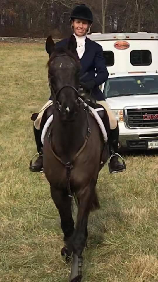 Wendy on a dark horse in formal hunt attire